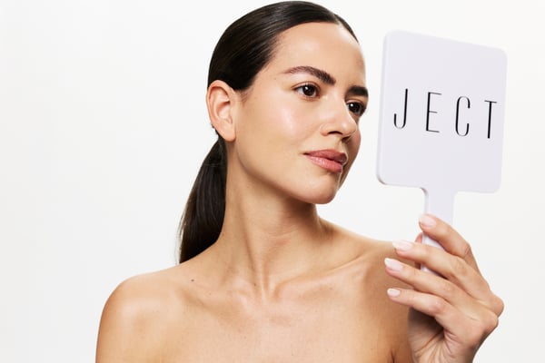 woman holding mirror branded with JECT