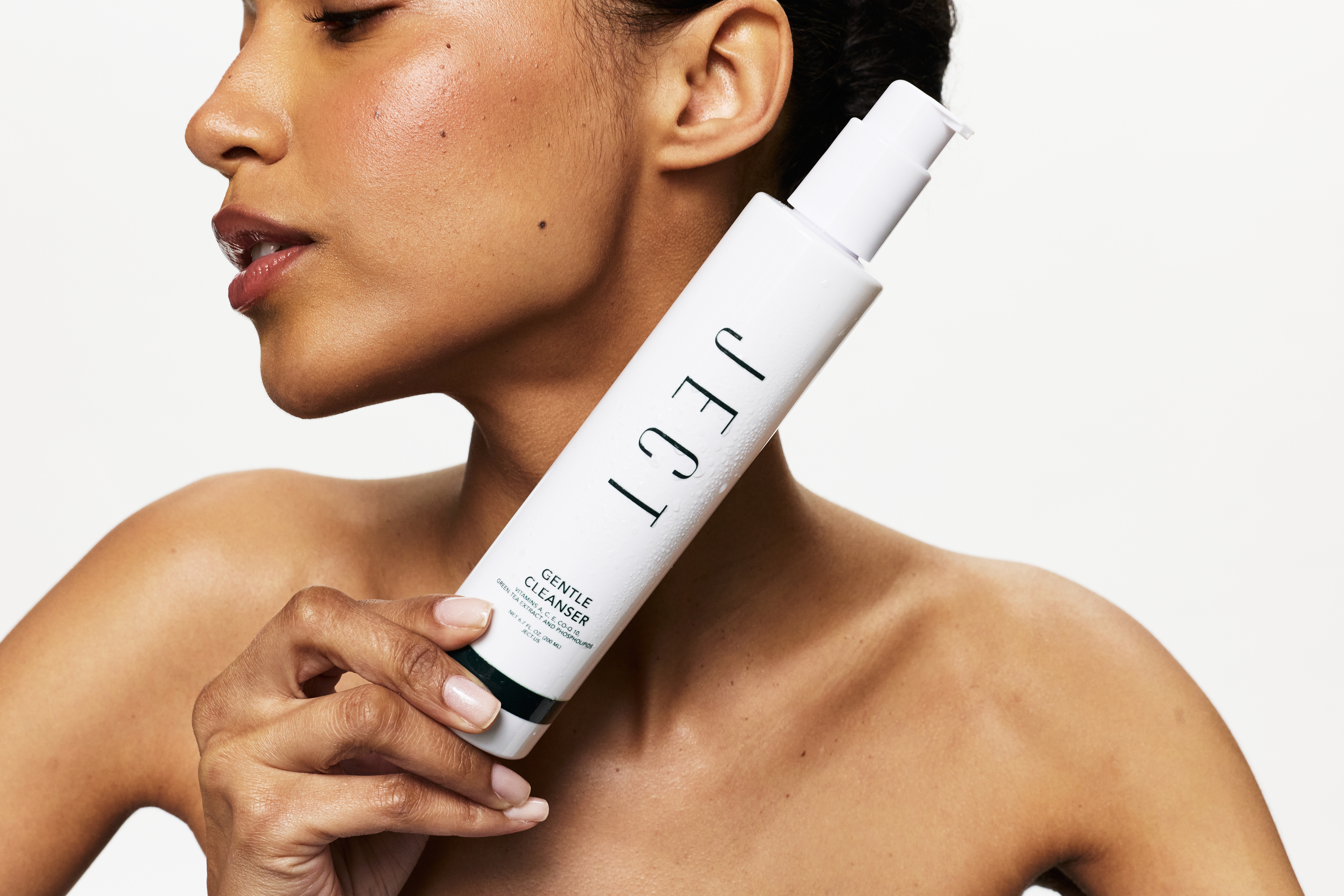 Woman holding JECT Gentle Cleanser